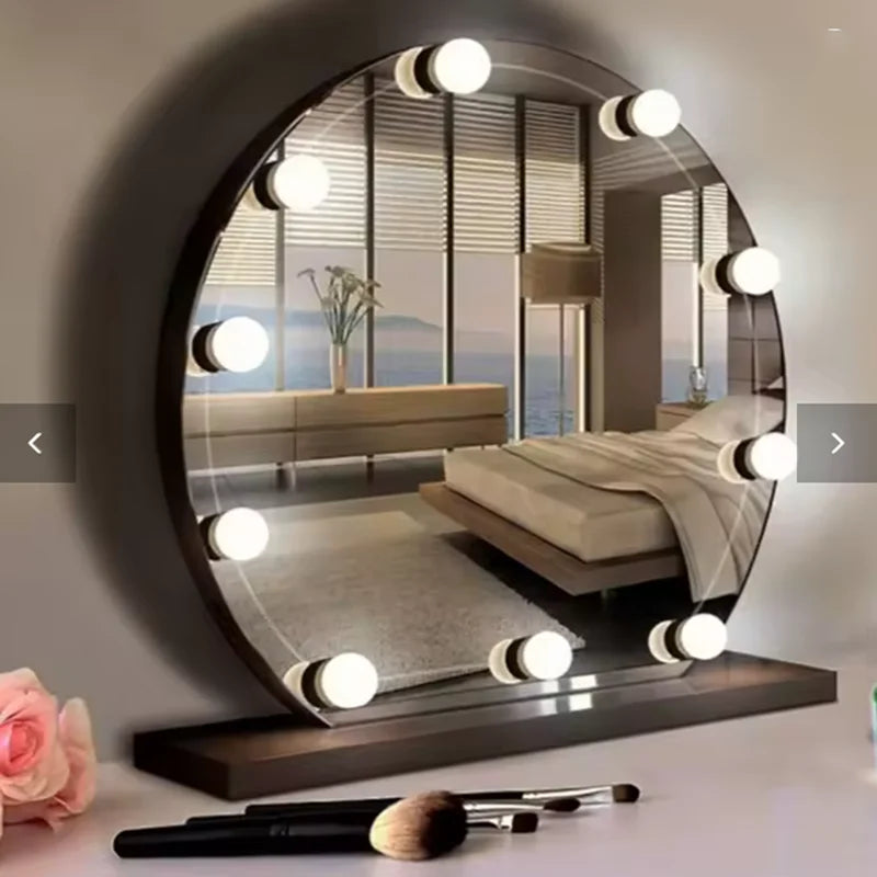 A round dimmable LED vanity mirror reflecting a bedroom and a makeup brush on a table.