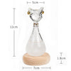 Clear glass bottle decoration shaped like an Egyptian cat with gold accents, used for weather forecast display.