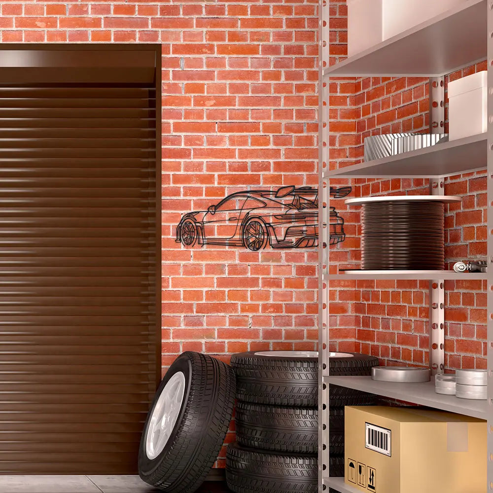 A black sports car silhouette metal wall art displayed on a wire shelving unit against a brick wall.