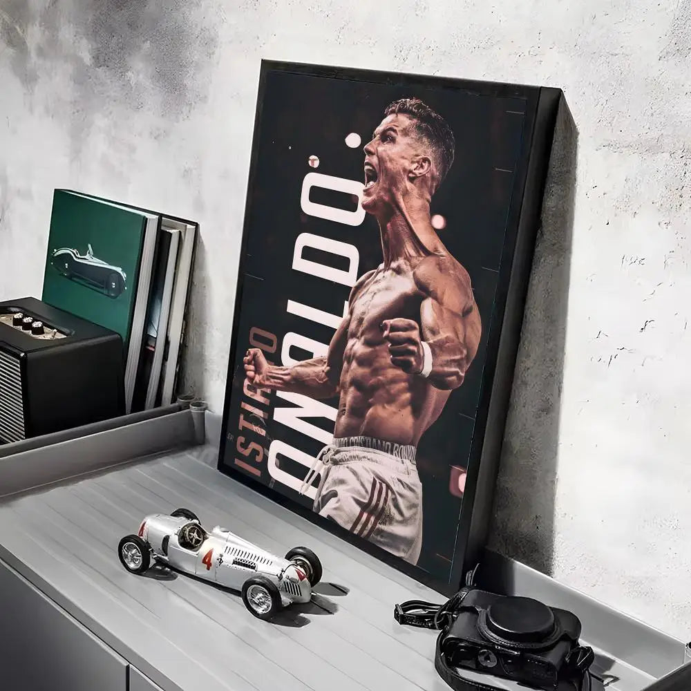 A framed canvas art poster featuring a muscular man in a football pose, displayed on a shelf.