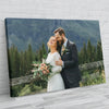 A portrait of a couple embracing outdoors with a blurred green forest background.