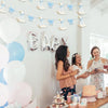 A silver and blue banner decoration featuring a goose shape with bowknot garlands for a party backdrop.
