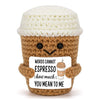 Handwoven knitted coffee cup cozy with a smiling brown doll decoration