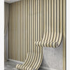 A section of faux wood grain self-adhesive wallpaper featuring vertical slats installed on a light gray wall.