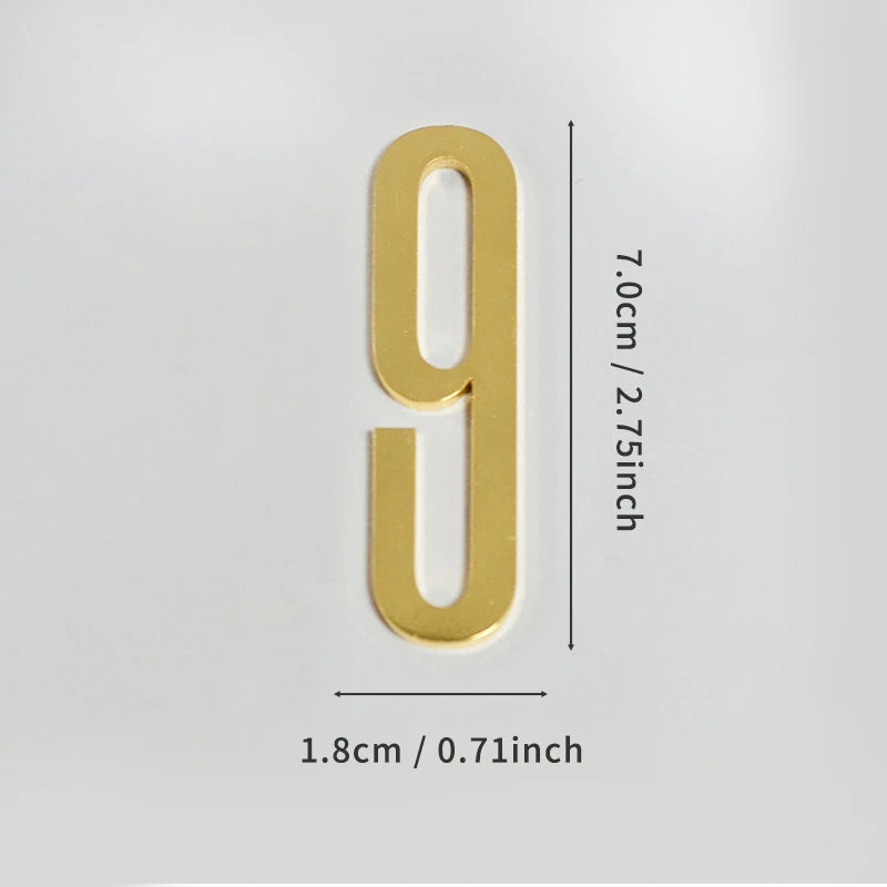 A polished gold house number 9 with a self-adhesive backing, measuring 7.0cm or 2.75 inches tall.