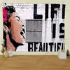 A black and white street graffiti art tapestry featuring a woman's profile and the text LIFE IS BEAUTIFUL on a brick backgrou