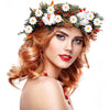 A woman wearing a floral crown made of artificial sunflowers and daisies with red berries and white fluff.