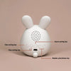 A white, rabbit-shaped mini LED cartoon alarm clock night light with various function buttons.