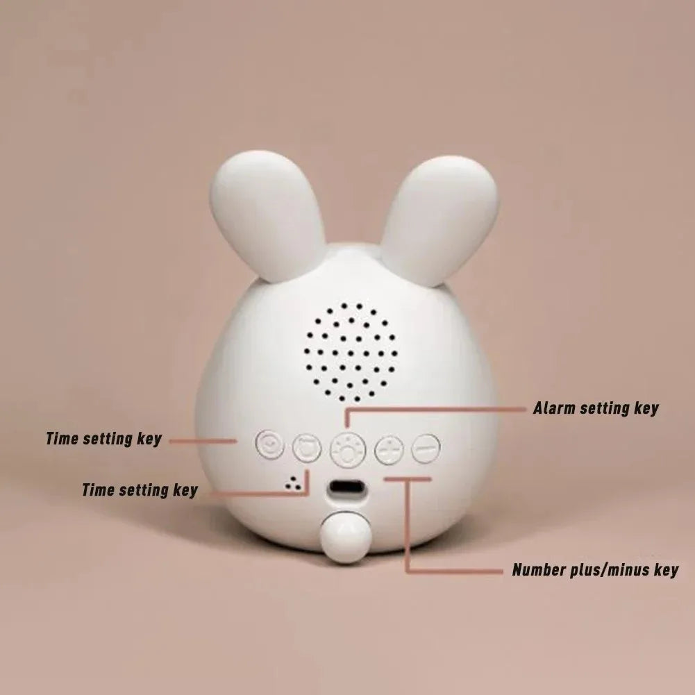A white, rabbit-shaped mini LED cartoon alarm clock night light with various function buttons.