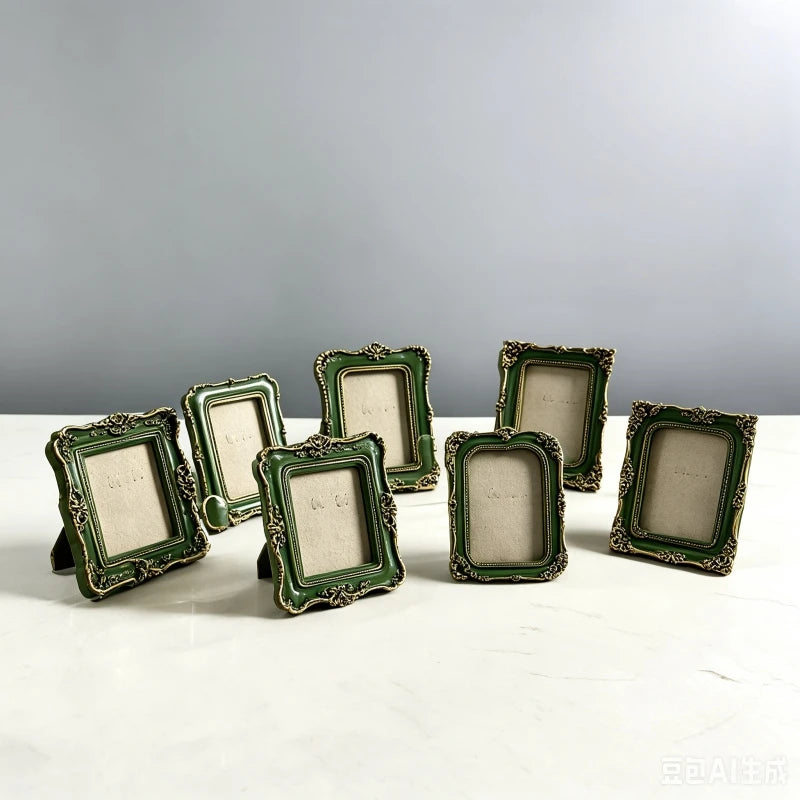 A collection of vintage baroque resin picture frames in olive green and gold accents displayed on a white surface.