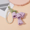 Handmade crocheted purple flowers on a pearl beaded keyring charm