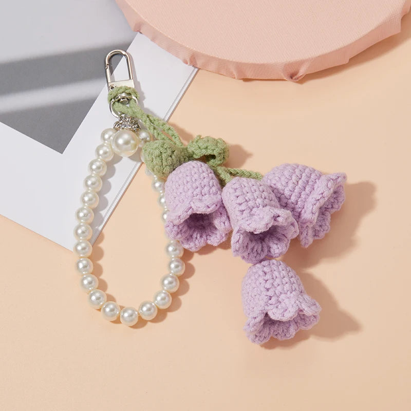 Handmade crocheted purple flowers on a pearl beaded keyring charm