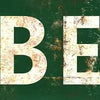 A distressed green metal sign with a white arrow pointing left and the word BEER.