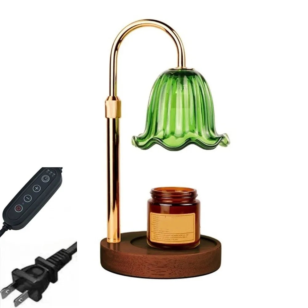 A brass adjustable height aromatherapy candle warmer lamp with a green glass shade and a wooden base.