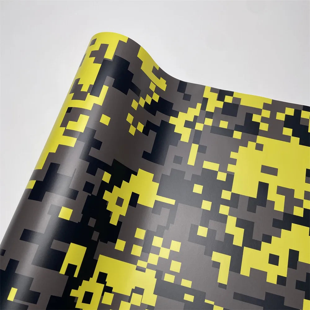 A roll of color-changing digital camouflage vinyl wrap film displaying a pattern of yellow and black shapes.
