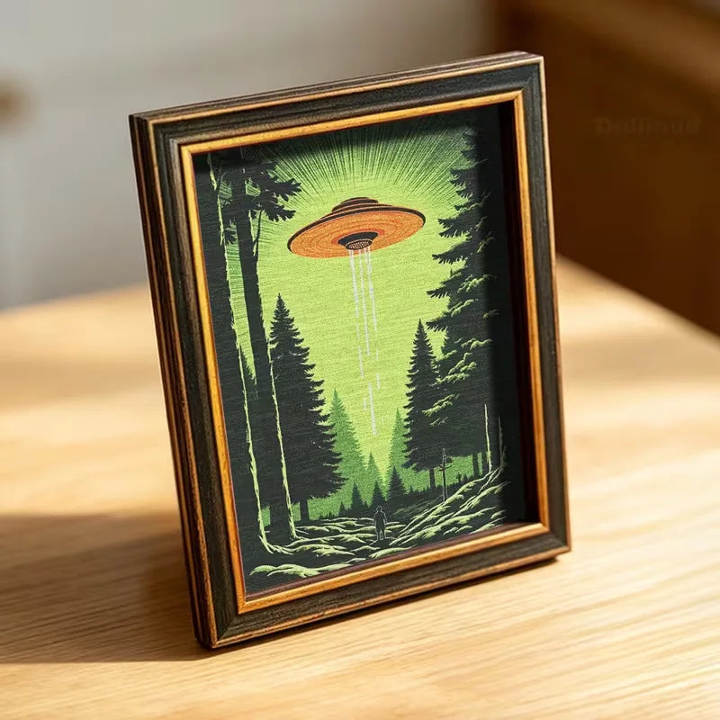 A framed nature scene featuring a glowing UFO above a forest landscape.