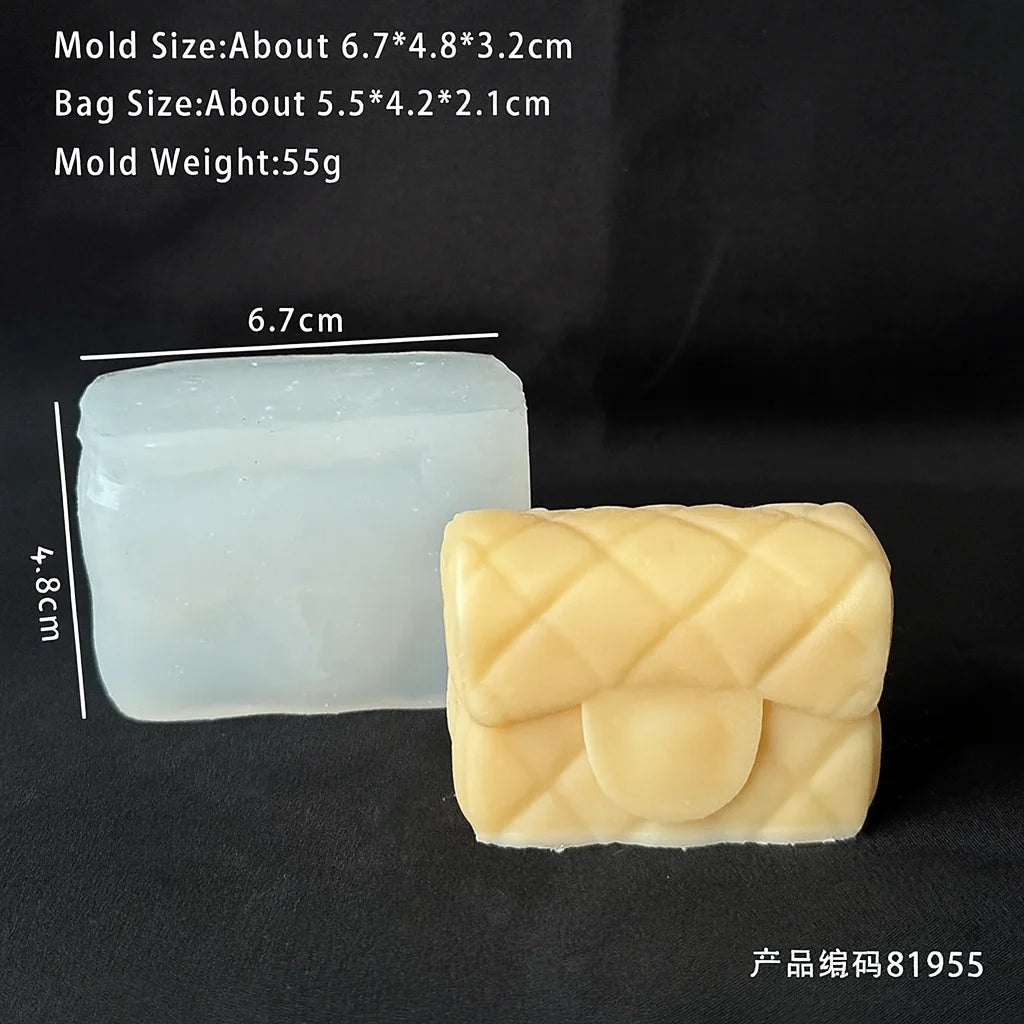 A light blue silicone mold and a yellow silicone handbag mold are displayed on a dark surface.