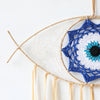 Handmade boho evil eye dream catcher wall decor featuring a white and blue geometric design