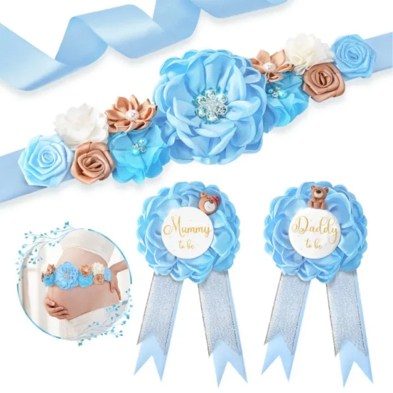 A set of blue floral maternity sash and corsage pins featuring roses and baby leaves.
