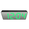 A rectangular digital alarm clock displaying the time 12:04 with bright green LED digits.