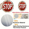 A vintage metal round stop sign with the word STOP in white lettering, shown next to a polished aluminum plate.