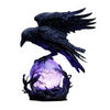 A black raven sculpture with purple glow perched on a dark base.
