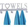 Decorative metal wall-mounted key holder with seven hooks displaying blue towels.