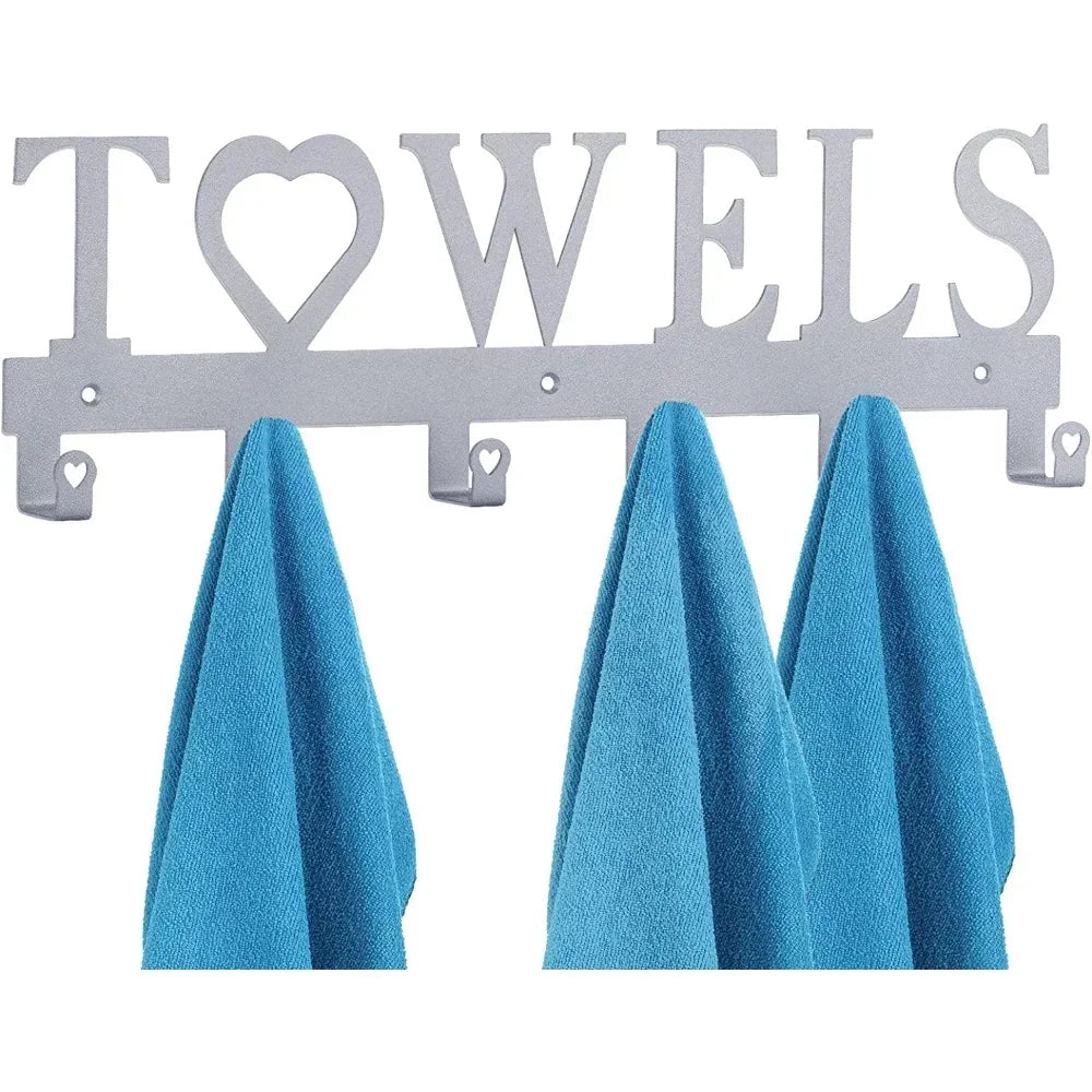 Decorative metal wall-mounted key holder with seven hooks displaying blue towels.