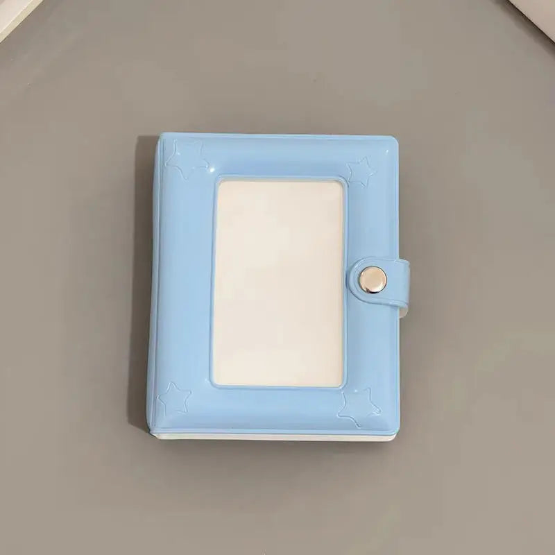 A light blue mini photo card binder with rounded corners and a clear plastic cover.