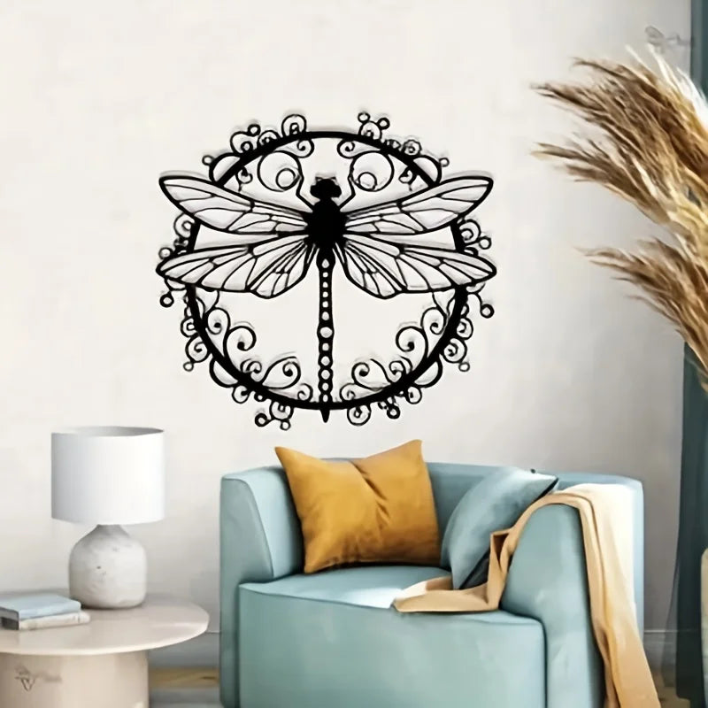 Elegant black dragonfly metal wall art silhouette displayed above a light blue armchair.