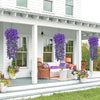 Artificial violet ivy hanging garland displayed in a porch setting with white siding and potted flowers