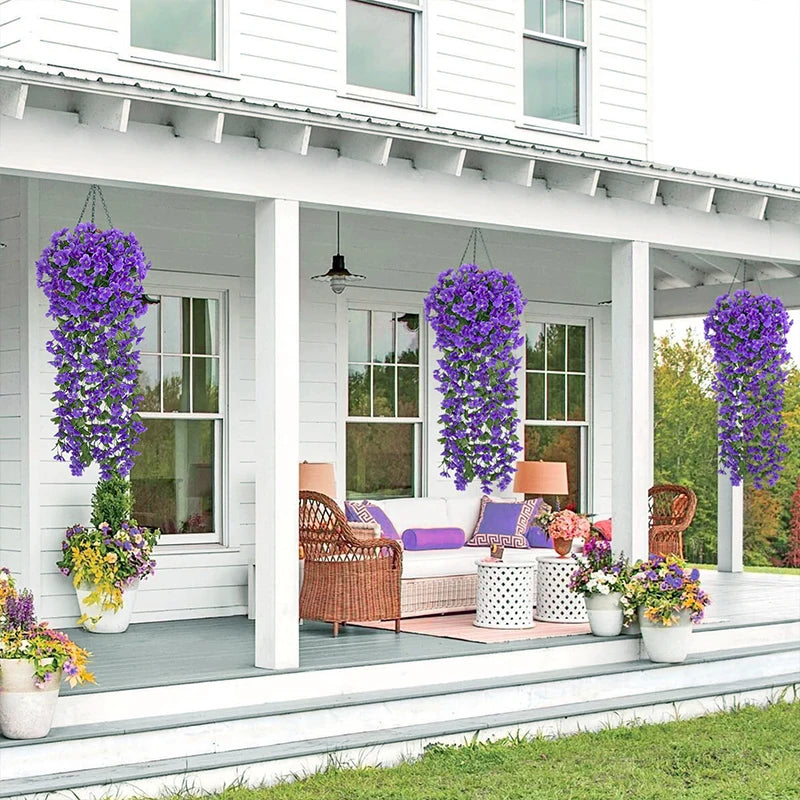 Artificial violet ivy hanging garland displayed in a porch setting with white siding and potted flowers