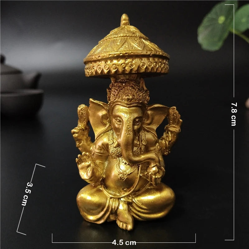 Gold bronze Ganesha Buddha statue with a conical crown and seated posture