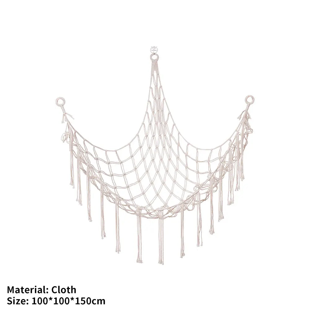 A beige cloth storage hammock suspended by strings, designed for toys and plushies.