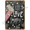 A rustic metal plaque featuring text that reads Keep Love Pippin surrounded by small white floral elements.