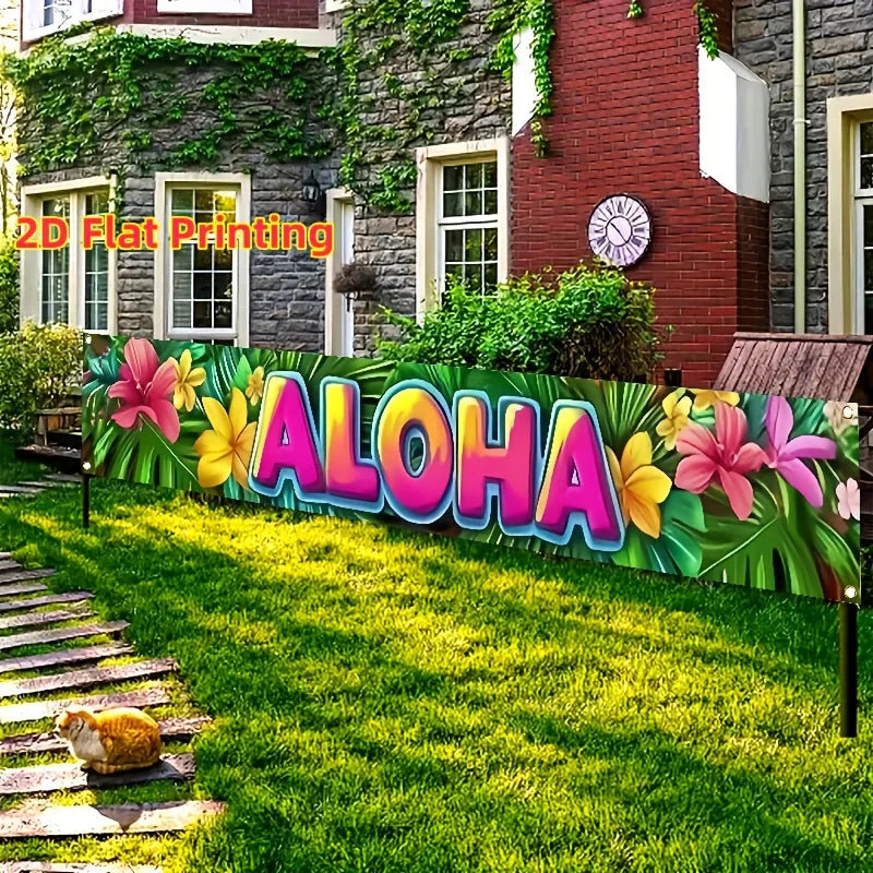 A vibrant green banner with the word ALOHA and colorful tropical flowers displayed outdoors on a sunny lawn.
