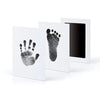 A set of three framed prints featuring black ink pet paw prints on white paper.