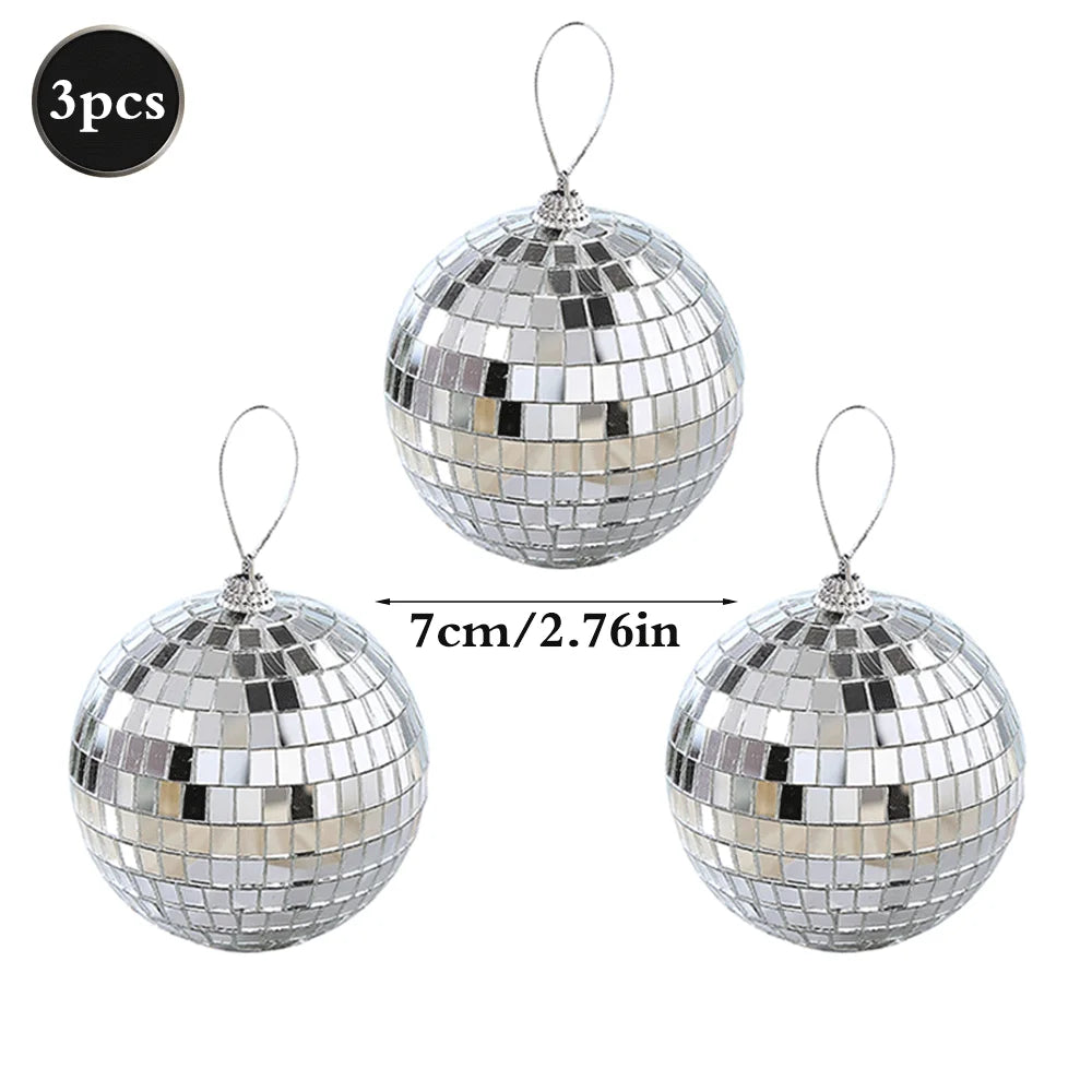 Three silver mirror balls with hanging hooks, sparkling and reflective.