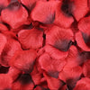 A close-up of deep red and dark purple silk rose petals for weddings and events.