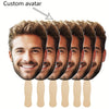 A row of custom face photo props on sticks showing various male faces for personalized party fans.