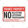 A vintage red and white warning sign with black text stating PRIVATE PROPERTY NO LOITERING TRESPASSING ALL OFFENDERS WILL BE 