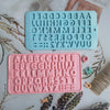 A pink silicone mold set featuring the alphabet and numbers in various fonts for baking