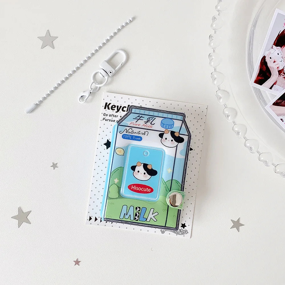A photo keychain featuring a cartoon milk bottle design on a card, with a silver keyring nearby.