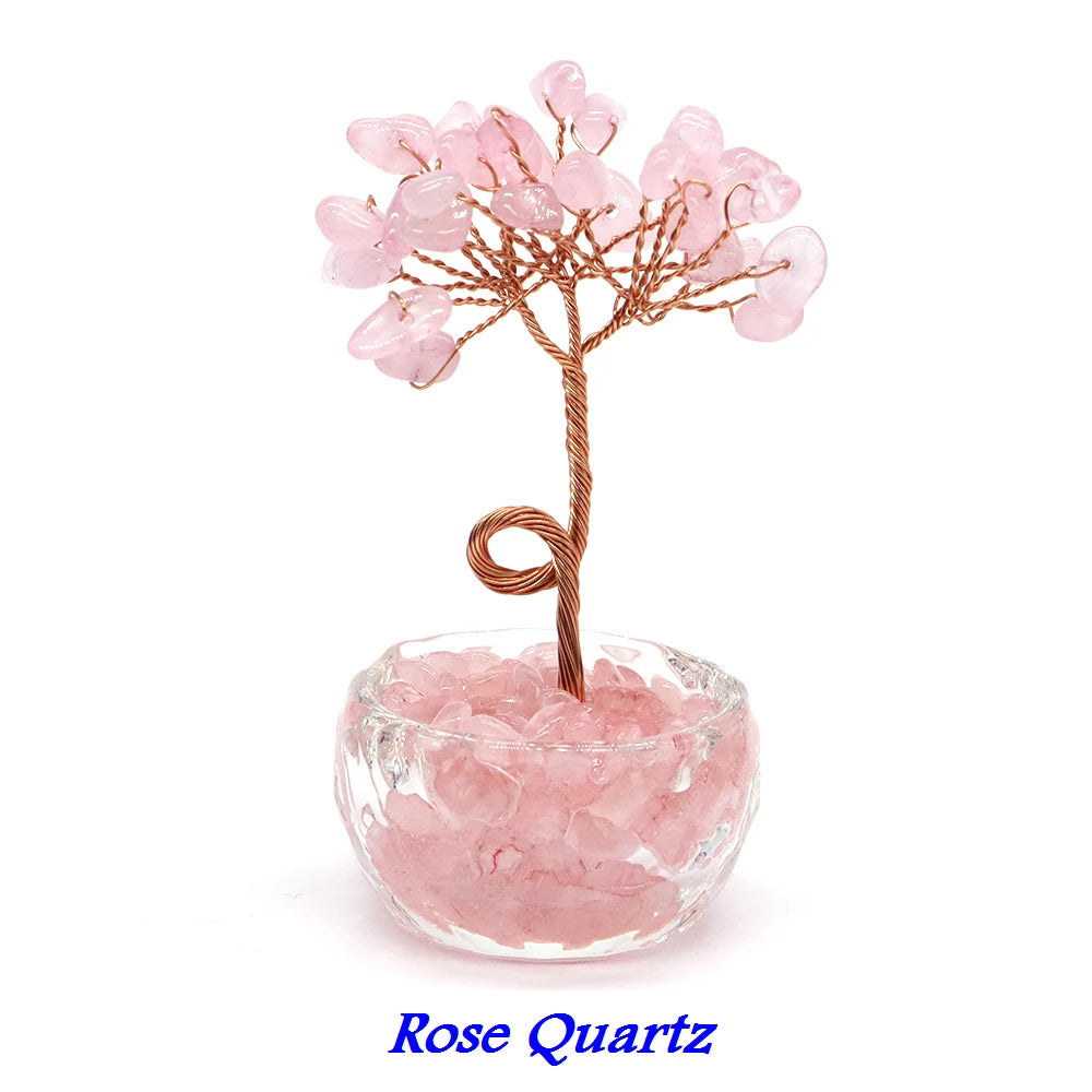 A Rose Quartz crystal bonsai tree with pink quartz blossoms growing from a clear glass base.