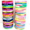 A stack of colorful silicone bracelets featuring the Jesus heart design in various shades of pink, blue, yellow, and green.