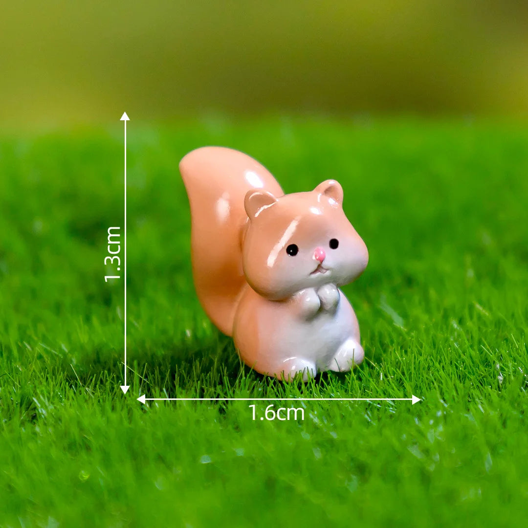 A small, light orange and white miniature animal figurine sitting on green grass.