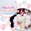 A tiered white cake decorated with pink and purple balloons and butterfly toppers on a stand.