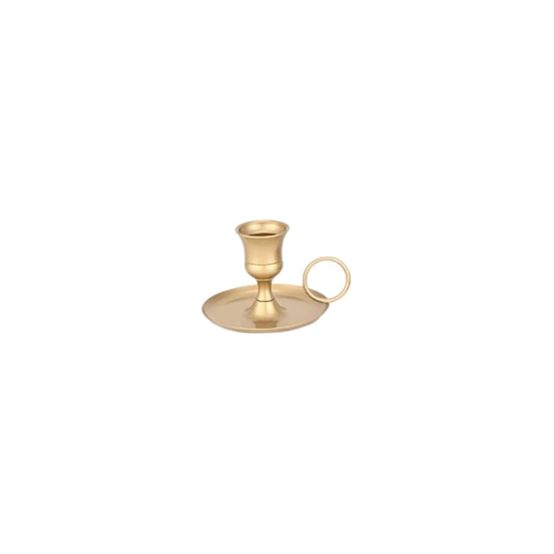 Elegant brass metal candle holder with a cup and a handle for dining or decor