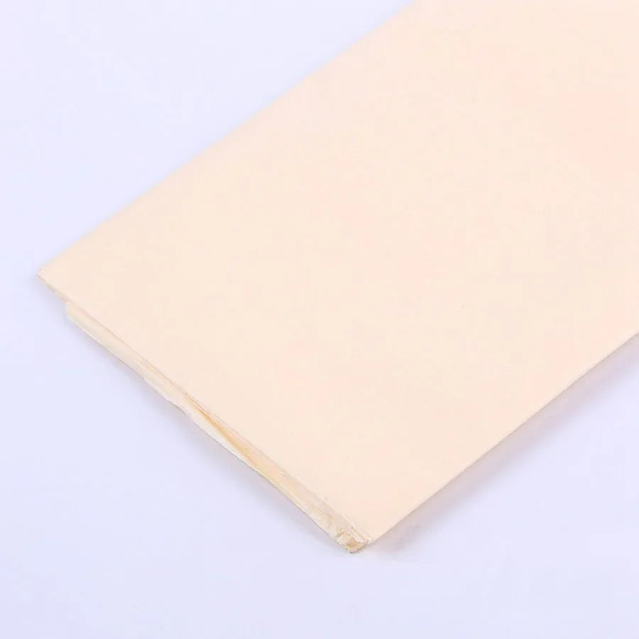 A stack of pale peach soft tissue paper sheets for gift wrapping and DIY crafts.