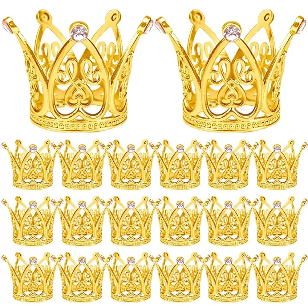 A collection of gold-colored mini crown cake toppers and decorations for weddings and birthdays.